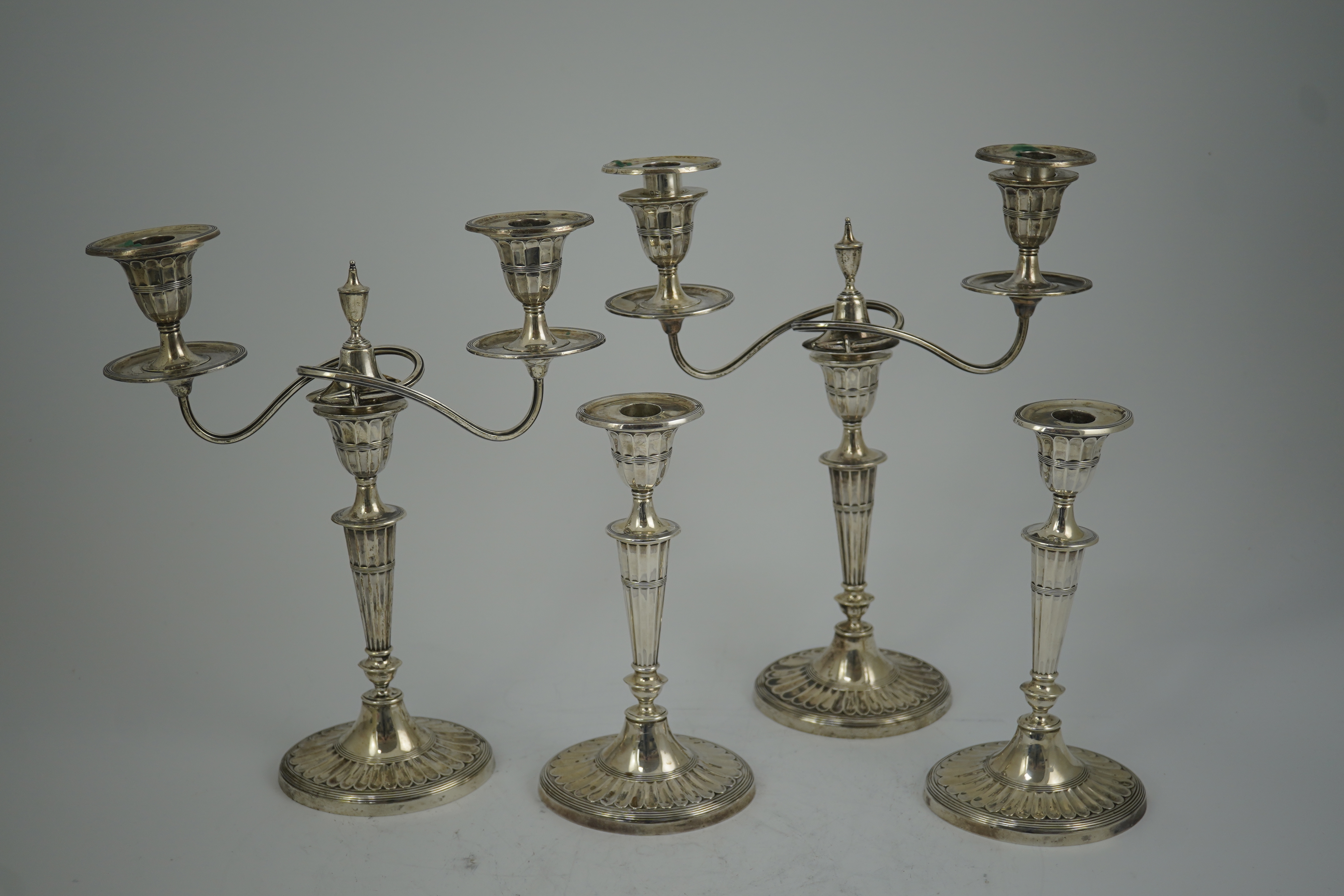 A pair of Edwardian silver two branch, two light candelabra, by Walker & Hall and a pair of matching candlesticks